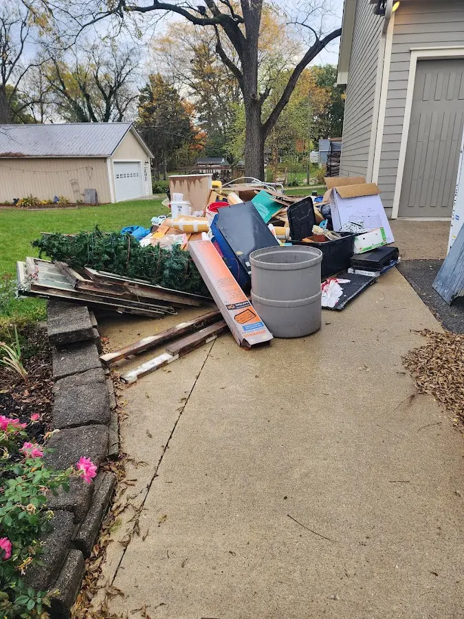 Dumpster being loaded with debris for Demolition Dumpster Rental in Rock Island